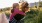 mother piggy backing her daughter on a dirt trail