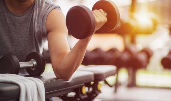 man curling weights